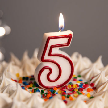 5th birthday candle on cake, celebrating five years of blogging.