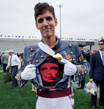 A photo of a US soldier opening his uniform to reveal a Che Guevara shirt.