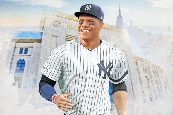 A photo of Juan Solo in front of a collage of Yankees Stadium and Manhattan.