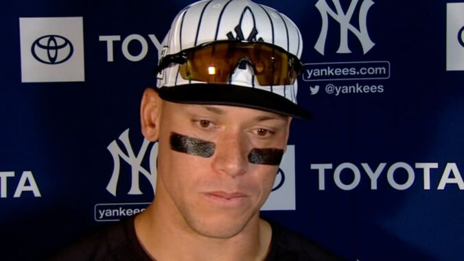 A photo of Yankees baseball player Aaron Judge with sunglasses over his hat.
