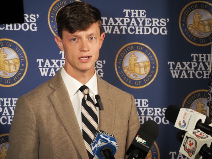 A photo of Iowa State Auditor Rob Sand against a background that reads 'The Taxpayers' Watchdog.'