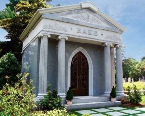 A photo of a large mausoleum with columns, used as a symbol for the death of academia.