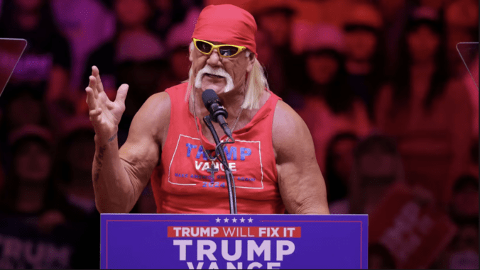 This is a photo of professional wrestler Hulk Hogan speaking in front of a Trump Vance sign, designed as a representation of the kayfabe presidency.