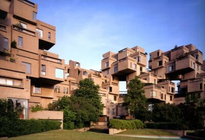 A photo of an interestingly shaped set of boxy apartments in a new housing development.