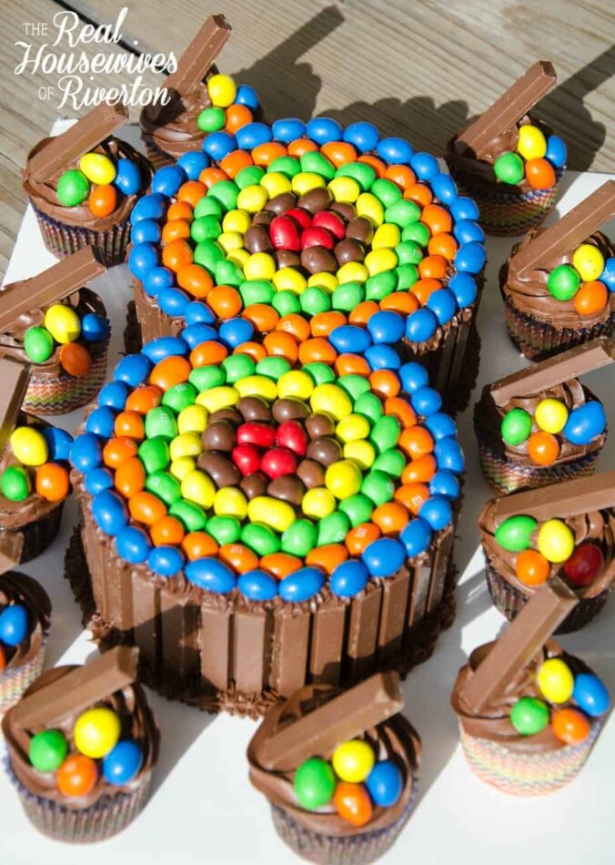 A representation of the number 8 made out with colored M&M candies in red, brown, yellow, green, orange, and blue.