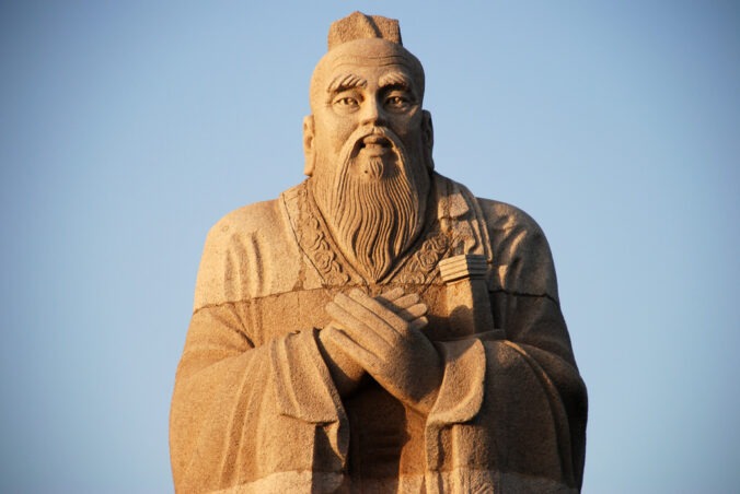 A large stone statue of Confucius.